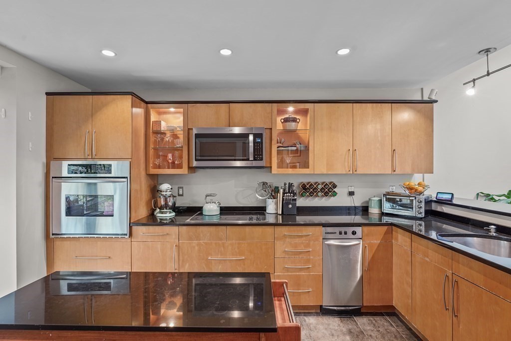 6 Shipway Place, Unit 6 Boston, MA 02129 - Photo 7 of 25 a kitchen with stainless steel appliances granite countertop a sink a stove and a microwave