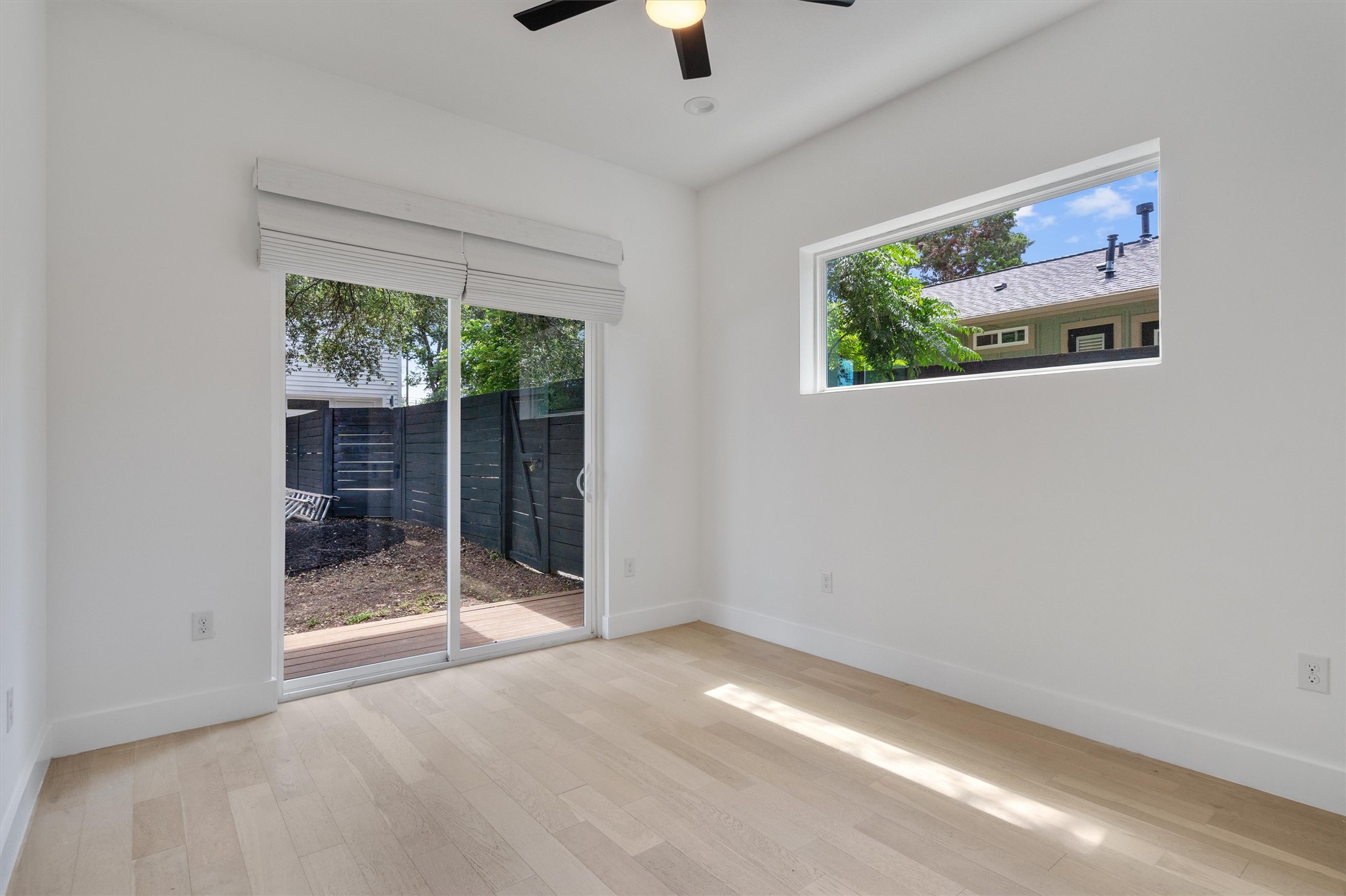 4712 Reyes Street, Unit 1 Austin, TX 78721 - Photo 11 of 38 a view of an empty room with a window and a ceiling fan