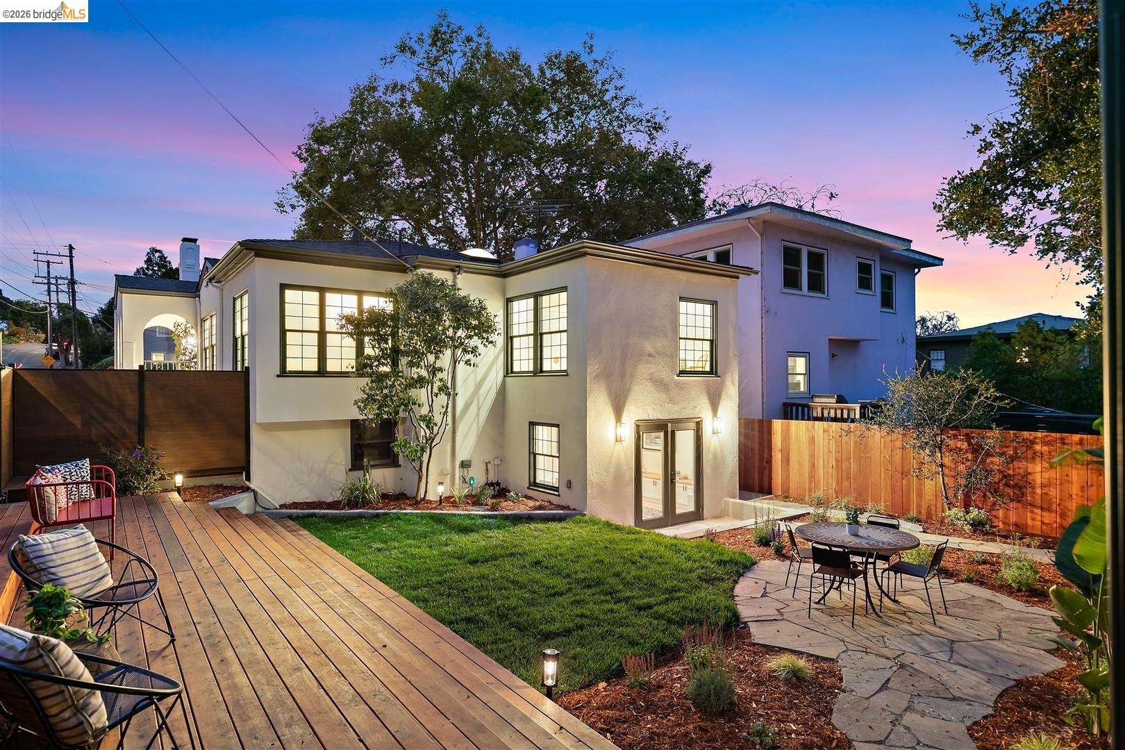 1668 Arch Street Berkeley, CA 94709 - Photo 52 of 78 Expansive wood deck with ground lighting, flagstone patio, and a manicured lawn
