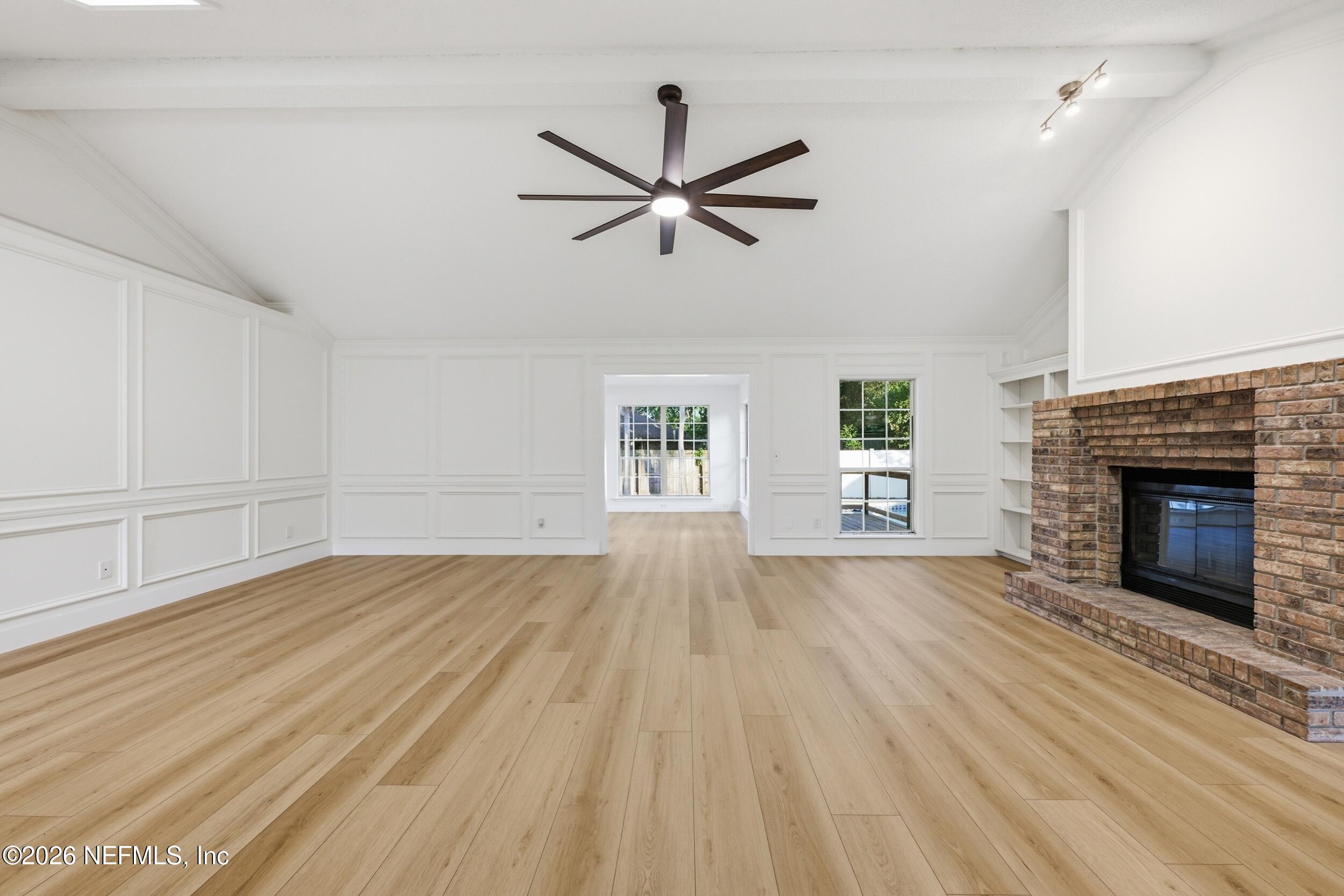 3286 Marbon Road Jacksonville, FL 32223 - Photo 6 of 36 an empty room with windows and fireplace