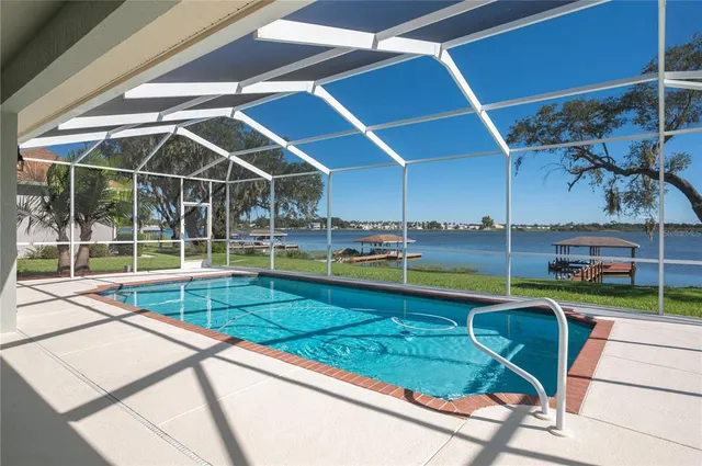 a view of a backyard with swimming pool