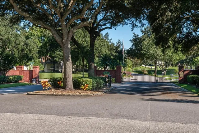 a view of a swimming pool with lawn chairs under an umbrella