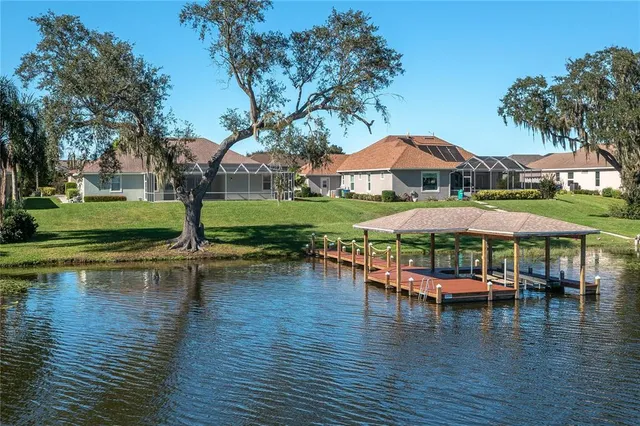 a view of a swimming pool with a table and chairs under an umbrella