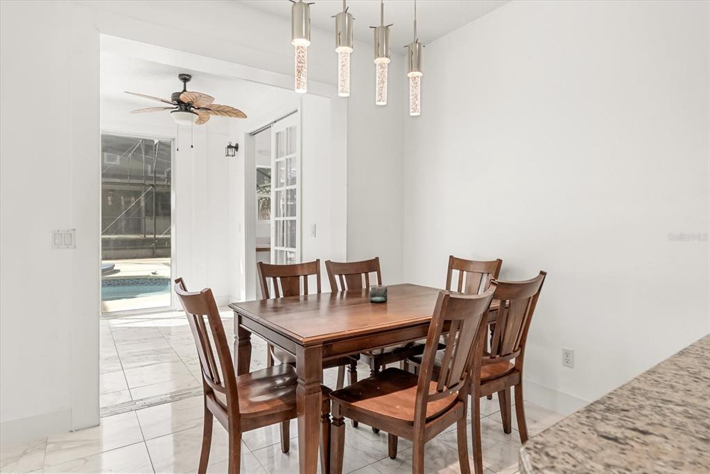 871 Blairmont Lane Lake Mary, FL 32746 - Photo 13 of 56 a view of a dining room with furniture and a chandelier