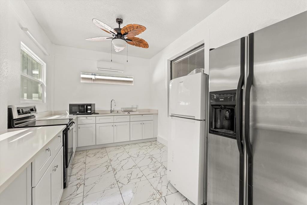 871 Blairmont Lane Lake Mary, FL 32746 - Photo 24 of 56 a kitchen with a refrigerator a sink and dishwasher
