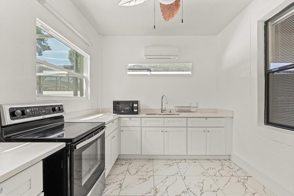 871 Blairmont Lane Lake Mary, FL 32746 - Photo 26 of 56 a kitchen with a sink stove and cabinets