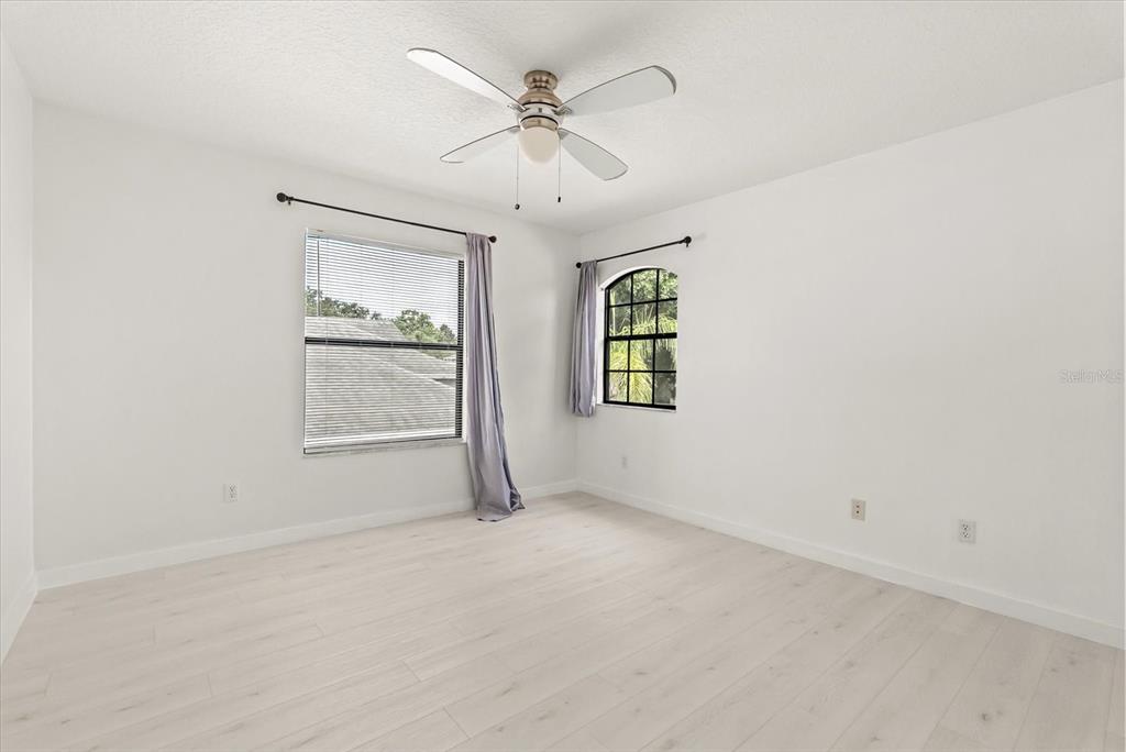 871 Blairmont Lane Lake Mary, FL 32746 - Photo 29 of 56 an empty room with windows and fan