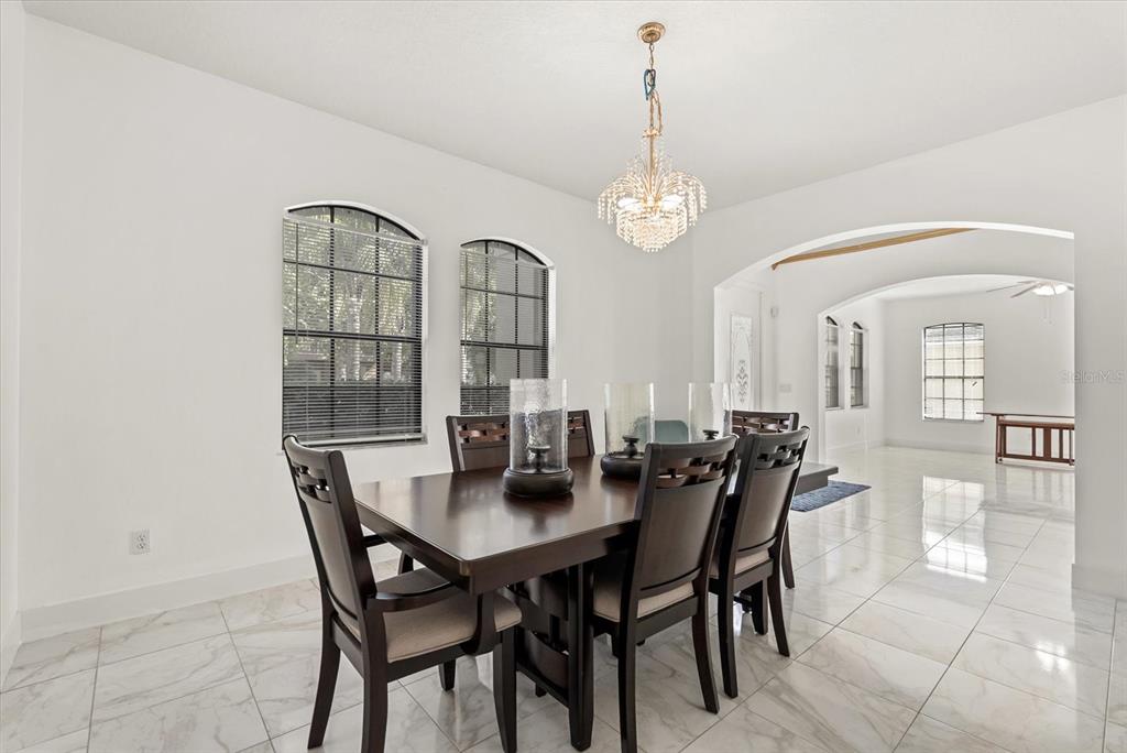 871 Blairmont Lane Lake Mary, FL 32746 - Photo 3 of 56 a view of a dining room with furniture and chandelier