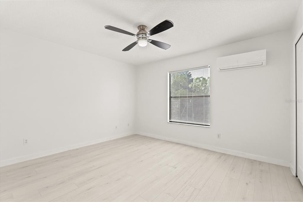 871 Blairmont Lane Lake Mary, FL 32746 - Photo 36 of 56 an empty room with a window and ceiling fan