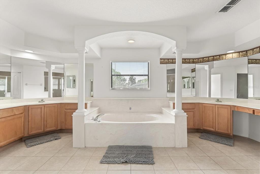 871 Blairmont Lane Lake Mary, FL 32746 - Photo 40 of 56 a spacious bathroom with a tub a sink and mirror