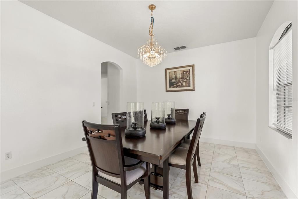 871 Blairmont Lane Lake Mary, FL 32746 - Photo 4 of 56 a view of a dining room with furniture and chandelier