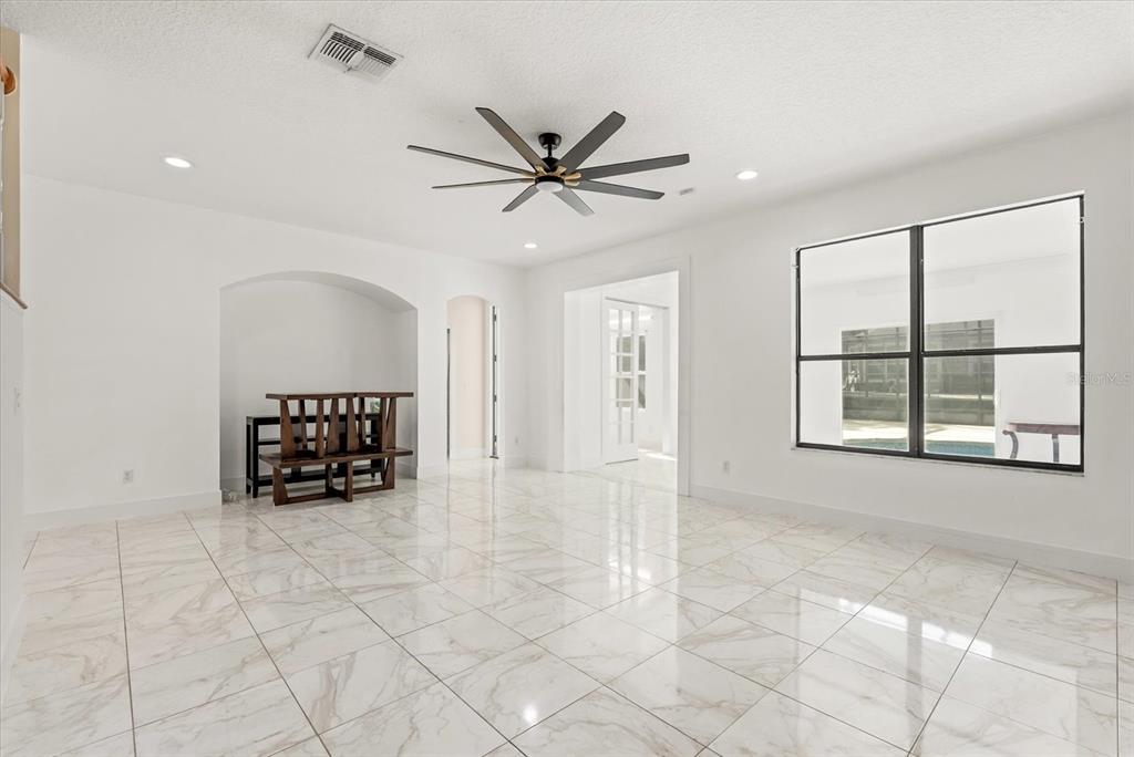 871 Blairmont Lane Lake Mary, FL 32746 - Photo 10 of 56 a view of a livingroom with a ceiling fan and window