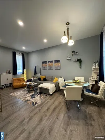 a living room with furniture and a chandelier