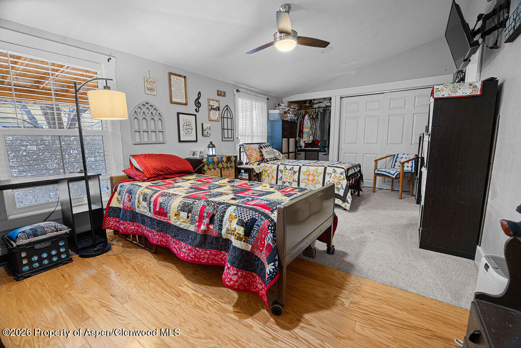 1464 Sage Street Craig, CO 81625 - Photo 16 of 47 a bedroom with a bed and wooden floor