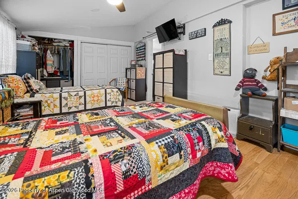 a bedroom with a bed and wooden floor