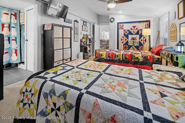 a bed sitting in a bedroom next to a window
