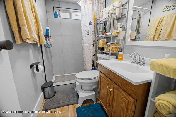 a bathroom with a sink toilet and shower