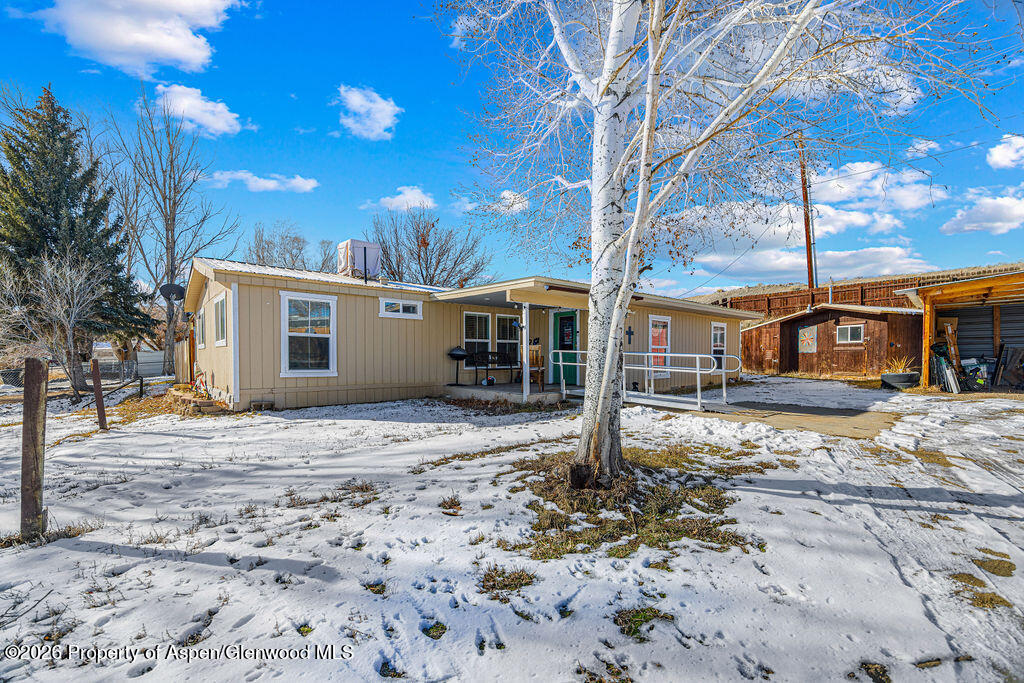 1464 Sage Street Craig, CO 81625 - Photo 29 of 47 a front view of a house with a tree