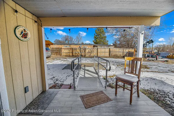 a view of a patio with a table and chairs