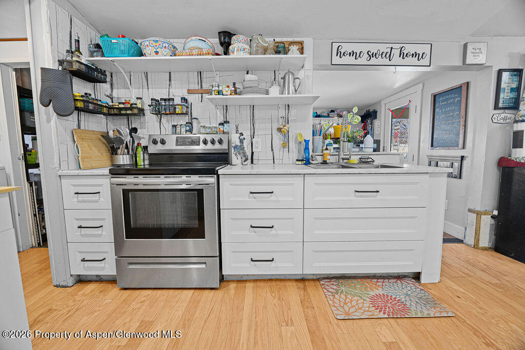 1464 Sage Street Craig, CO 81625 - Photo 8 of 47 a kitchen with stainless steel appliances granite countertop a stove and cabinets