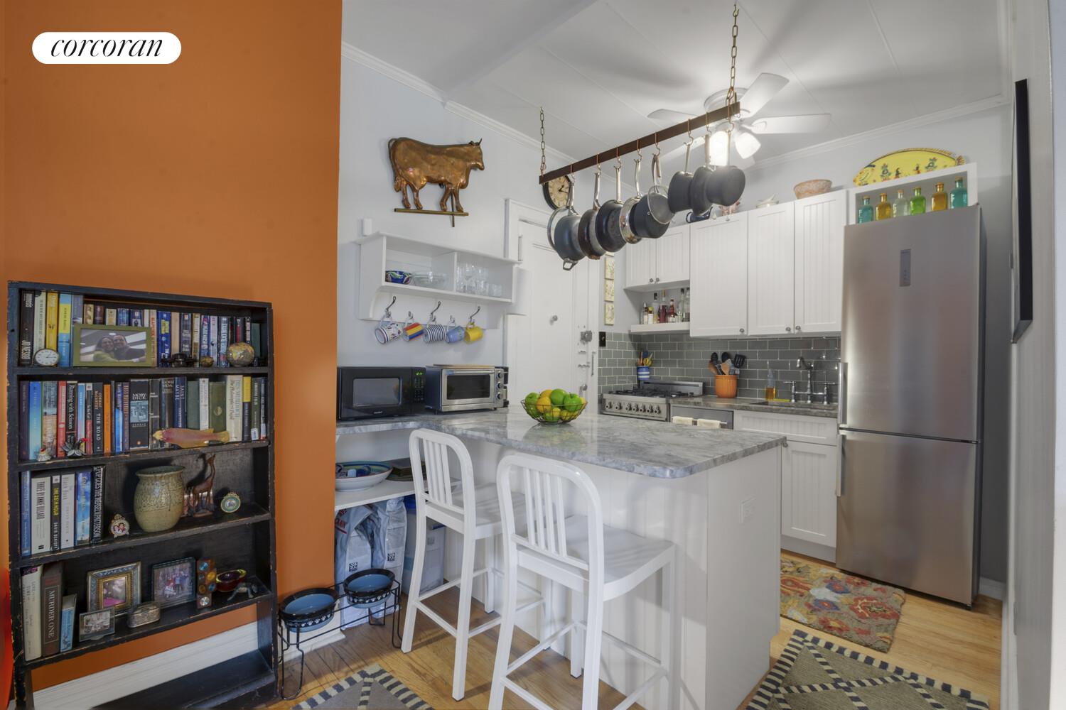 116 Pinehurst Avenue, Unit D1 Manhattan, NY 10033 - Photo 4 of 17 a kitchen with stainless steel appliances granite countertop a refrigerator and a stove top oven