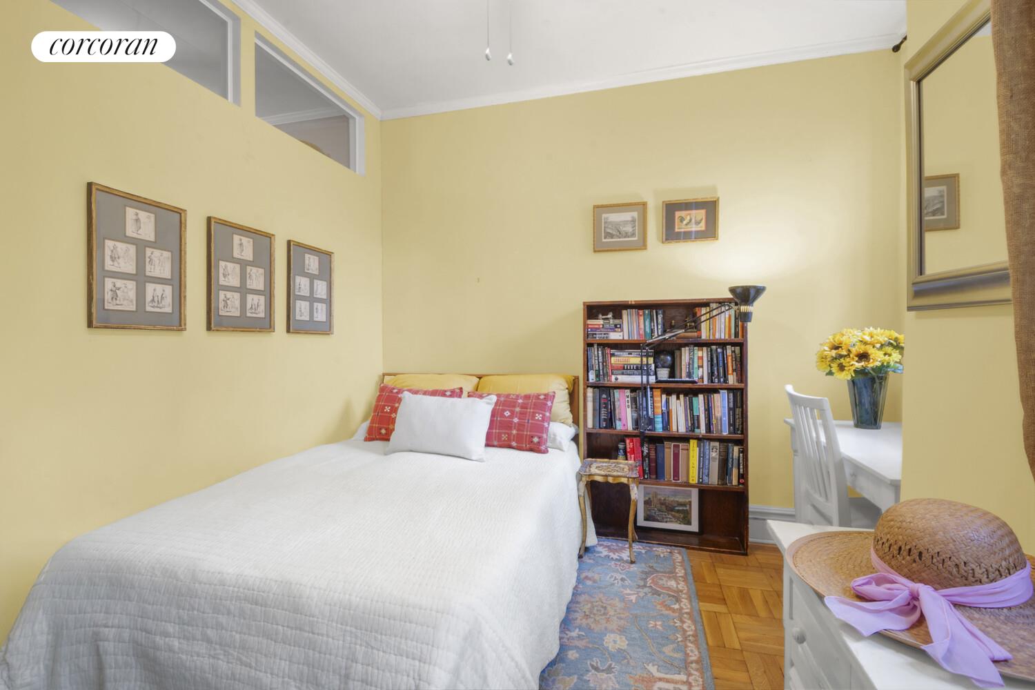 116 Pinehurst Avenue, Unit D1 Manhattan, NY 10033 - Photo 6 of 17 a bedroom with a bed and a book shelf