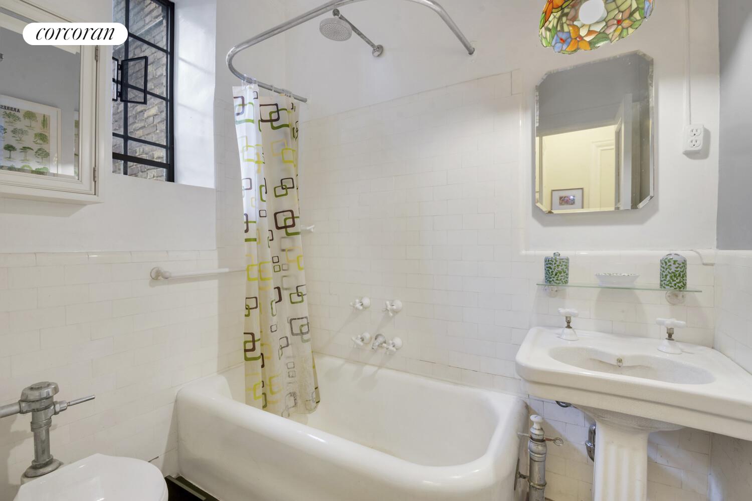 116 Pinehurst Avenue, Unit D1 Manhattan, NY 10033 - Photo 7 of 17 a bathroom with a sink a toilet and shower