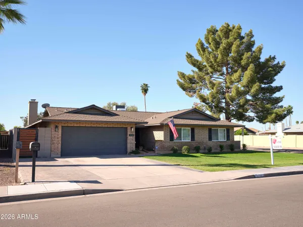 a front view of house with yard and outdoor seating