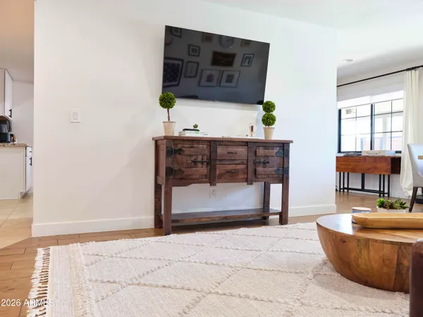 a living room kitchen with stainless steel appliances kitchen island granite countertop furniture and a kitchen view