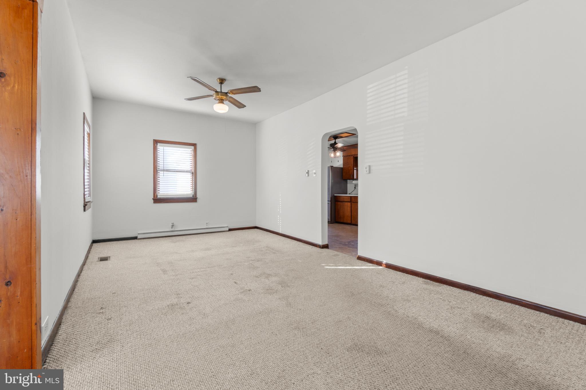 262 Laurel Street Carneys Point, NJ 08069 - Photo 3 of 12 an empty room with windows and ceiling fan
