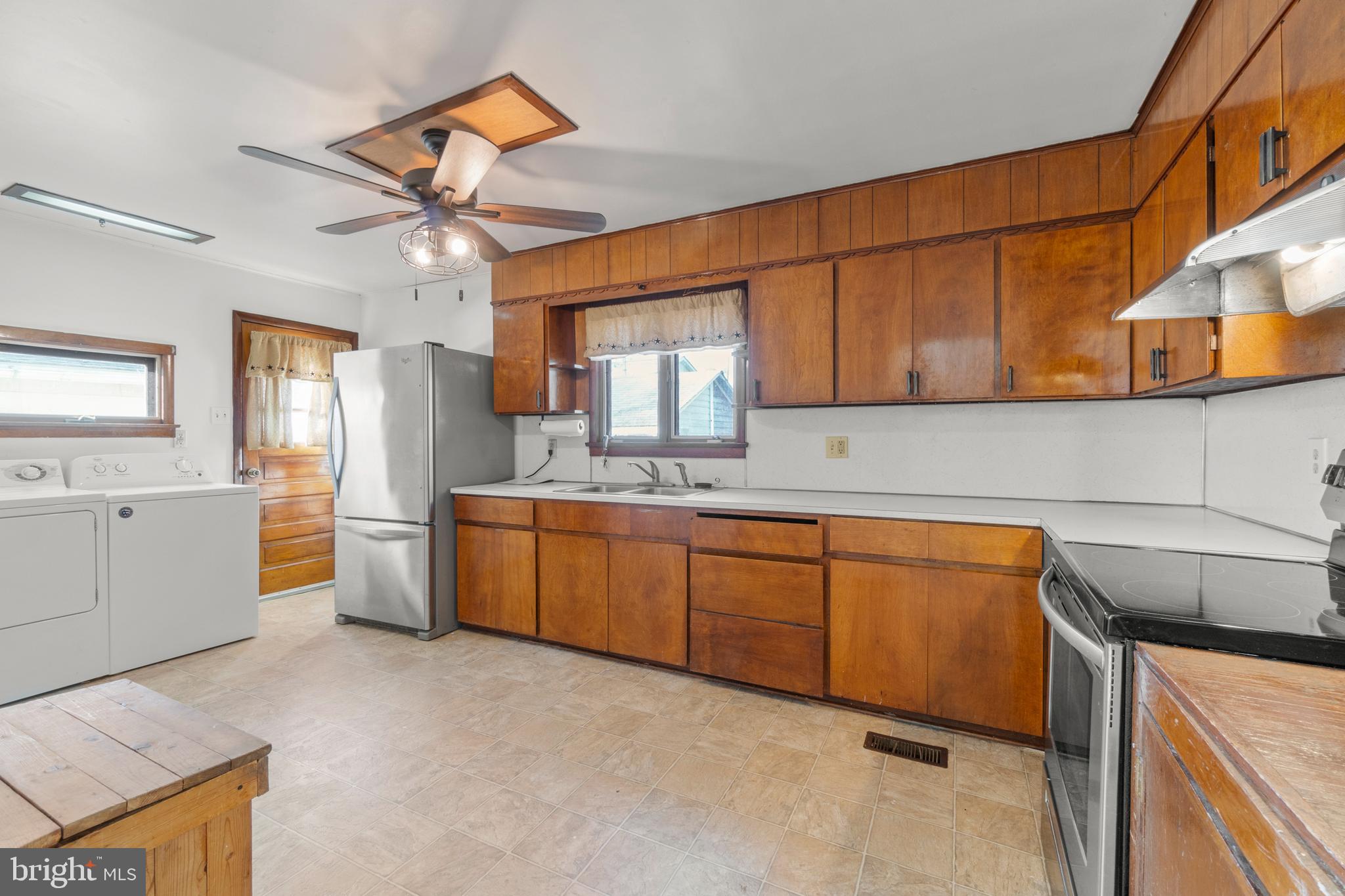 262 Laurel Street Carneys Point, NJ 08069 - Photo 5 of 12 a kitchen with stainless steel appliances granite countertop a sink and cabinets