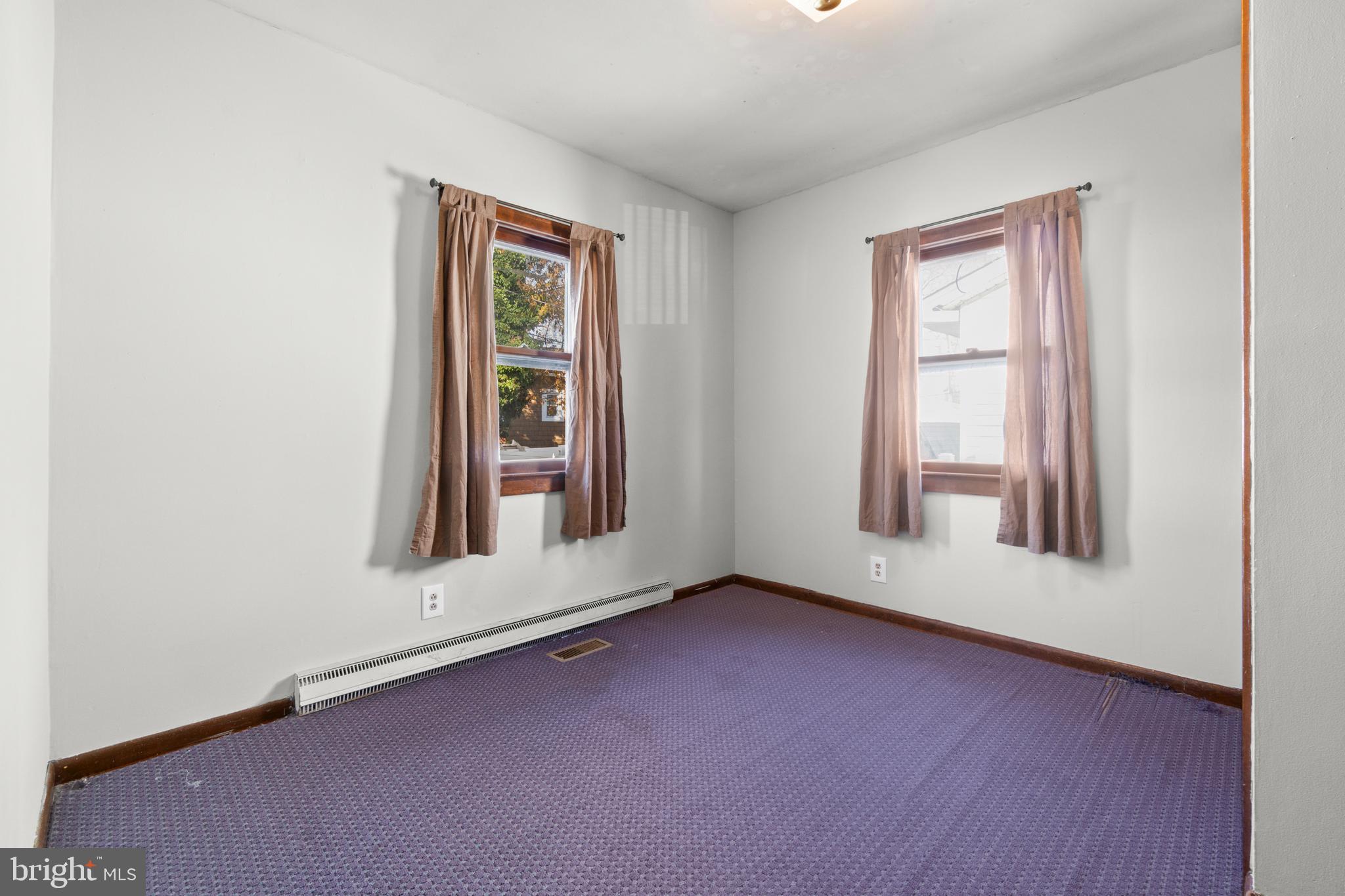 262 Laurel Street Carneys Point, NJ 08069 - Photo 9 of 12 an empty room with wooden floor and windows