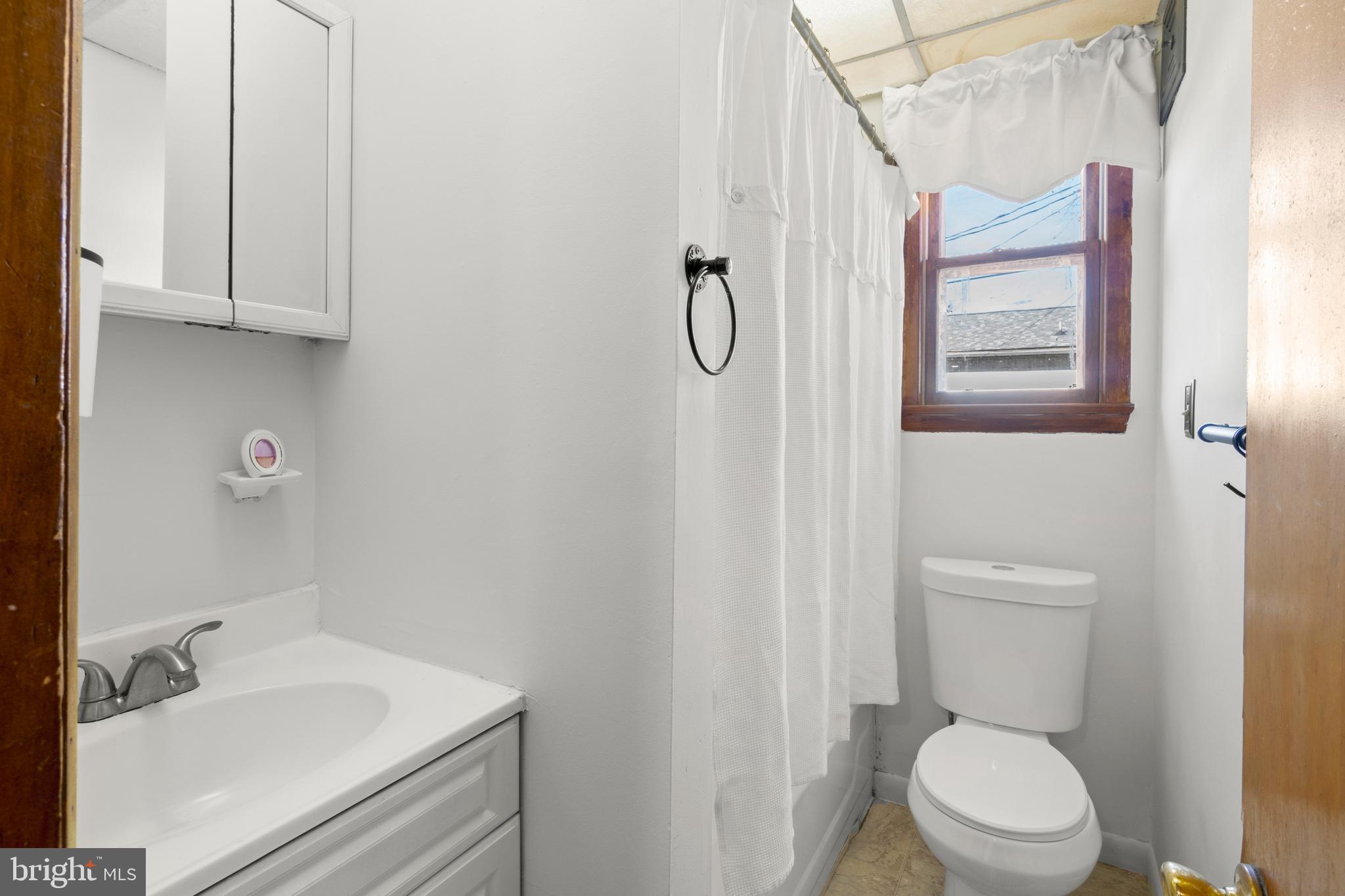 262 Laurel Street Carneys Point, NJ 08069 - Photo 10 of 12 a white toilet sitting next to a bathroom sink