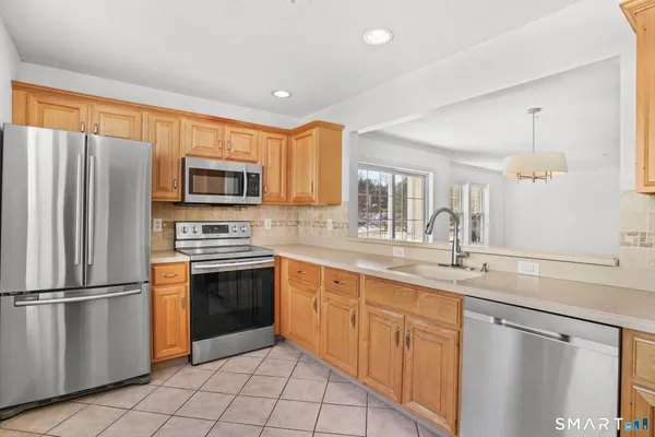 a kitchen with a sink stainless steel appliances and cabinets