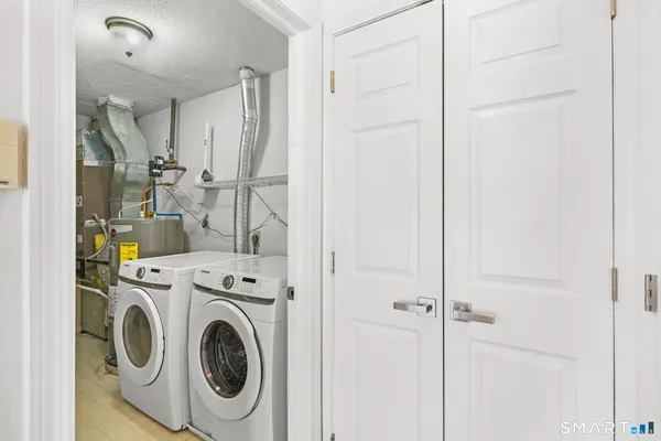 a view of storage and utility room with washer and dryer