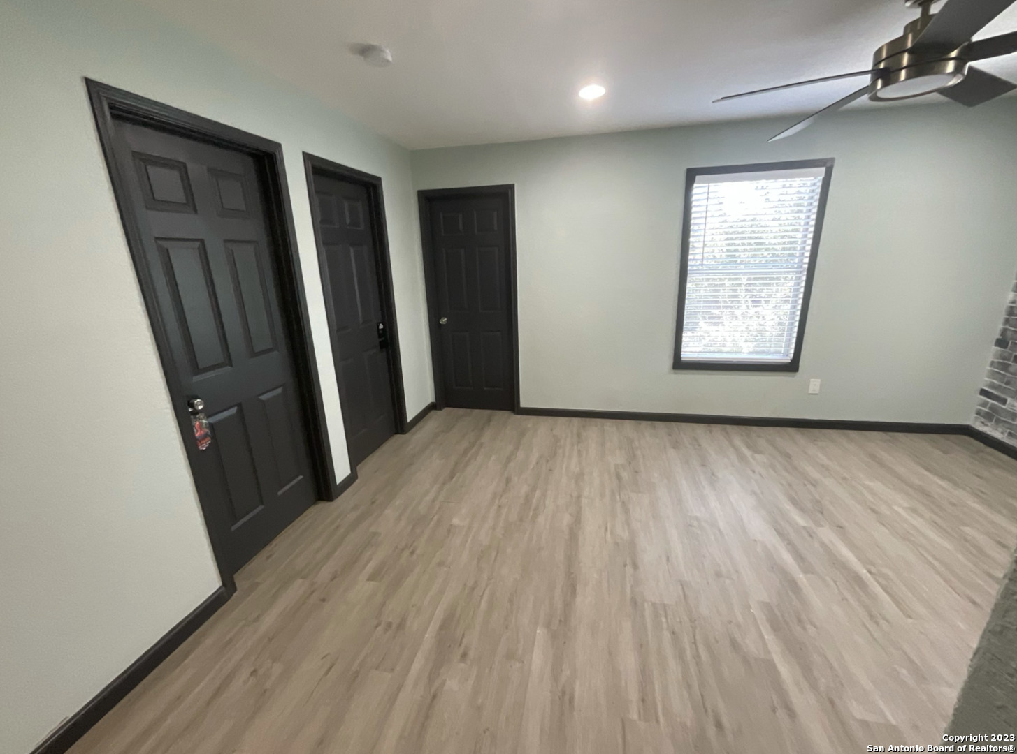 6650 Hartnet Fields Converse, TX 78109 - Photo 14 of 29 an empty room with wooden floor and windows