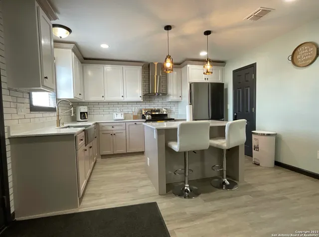 a kitchen with a sink cabinets and window