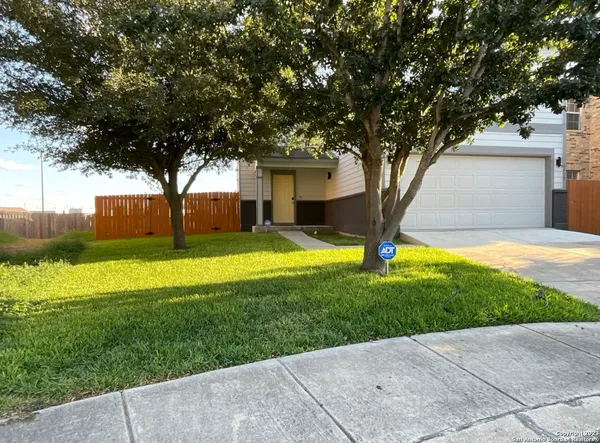 a view of a house with a backyard