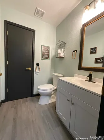 a spacious bathroom with a toilet sink a shower and vanity