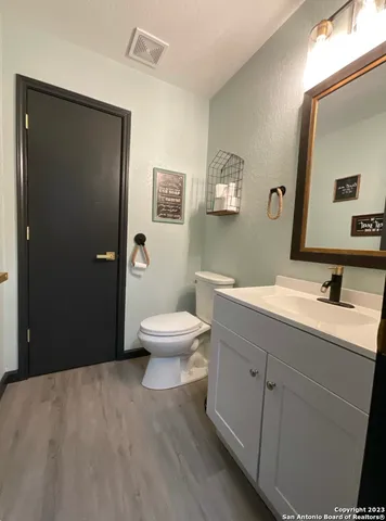 a spacious bathroom with a toilet sink a shower and vanity