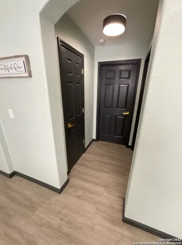 an entryway with a wooden floor and cabinet
