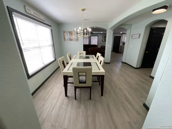 a view of a dining room with furniture window and wooden floor