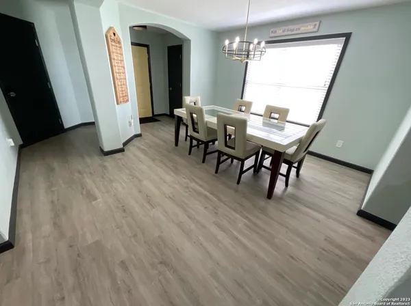 a dining room with furniture and window