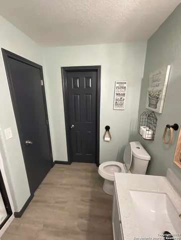 a bathroom with a toilet and a sink