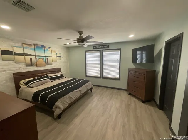 a bedroom with a bed and wooden floor