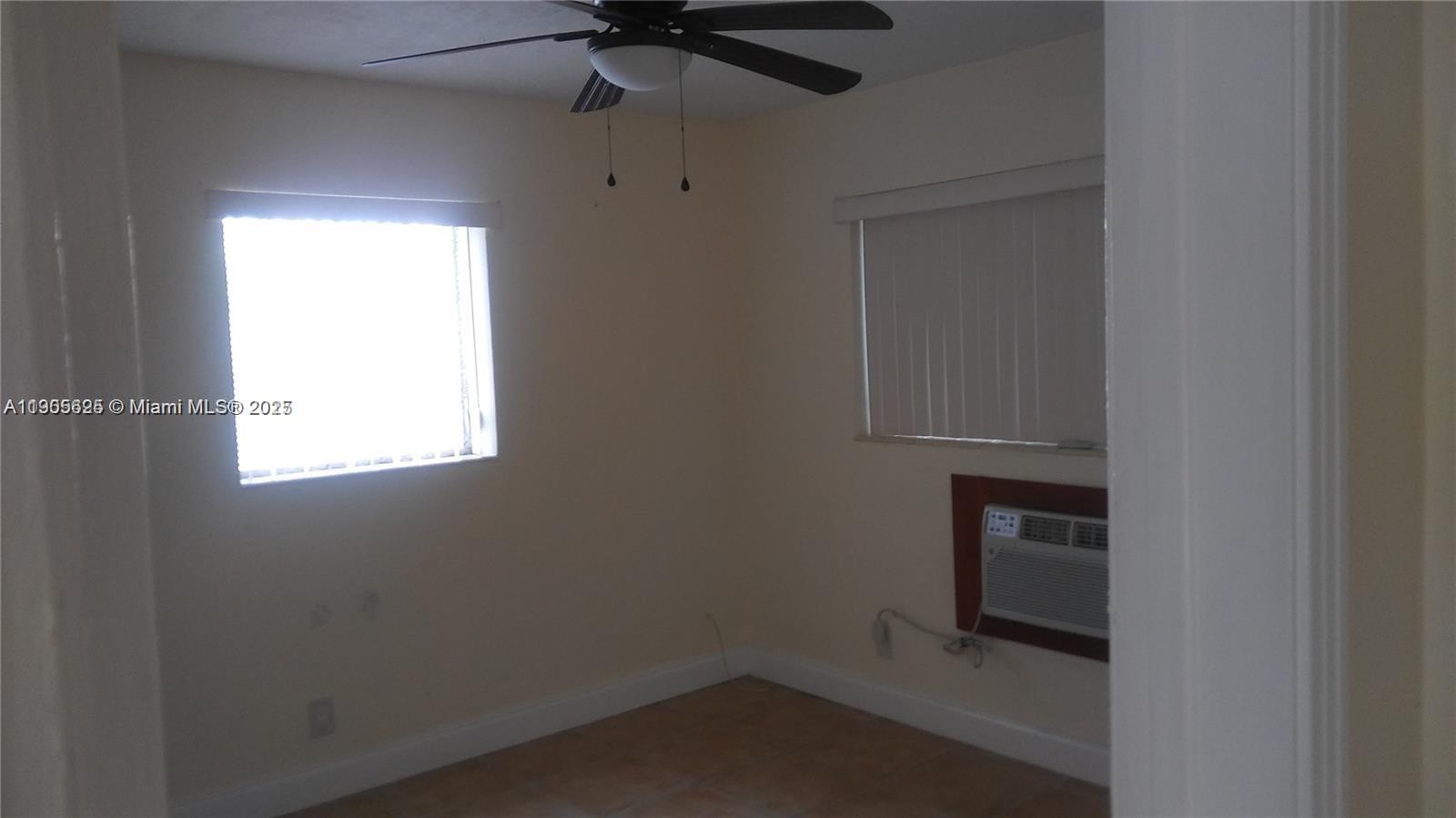 2441 Southwest 27th Avenue, Unit 3 Miami, FL 33145 - Photo 3 of 4 an empty room with a window