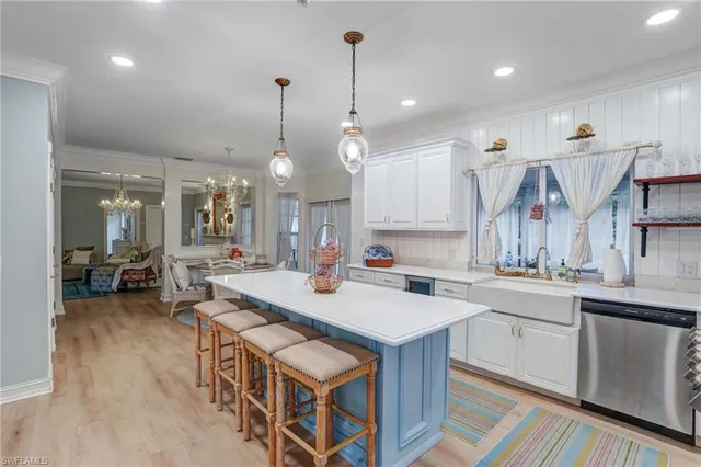 a open kitchen with stainless steel appliances granite countertop a sink a stove and a wooden floors