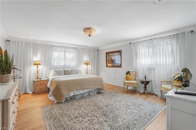 a bathroom with a granite countertop double vanity and a mirror