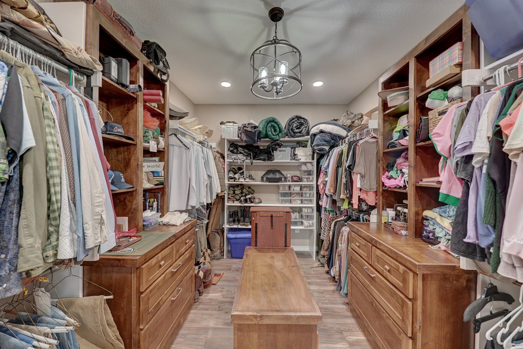8177 Wendel Road Harper, TX 78631 - Photo 15 of 32 a view of walk in closet with clothes and shoes