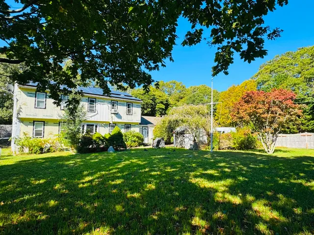 a view of a house with a tree in a yard